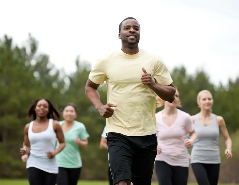 Fatigue Fighting Strategies #4: Find a Buddy. Man jogging with several other people around him.