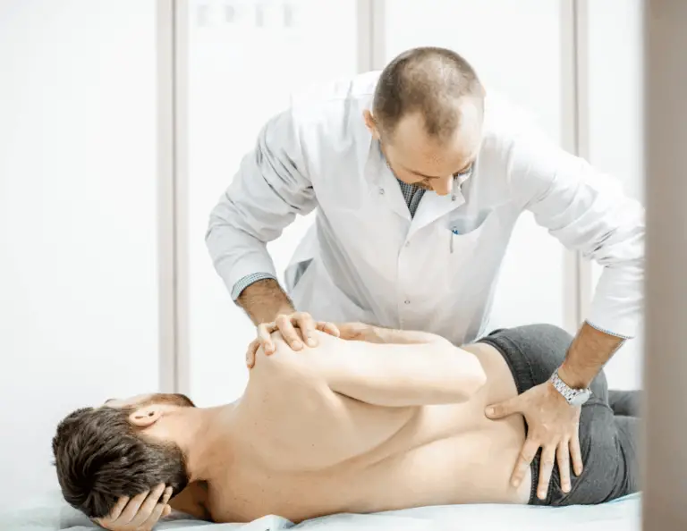physical therapist performing spinal manipulation on lumbar spine of patient in sidelying